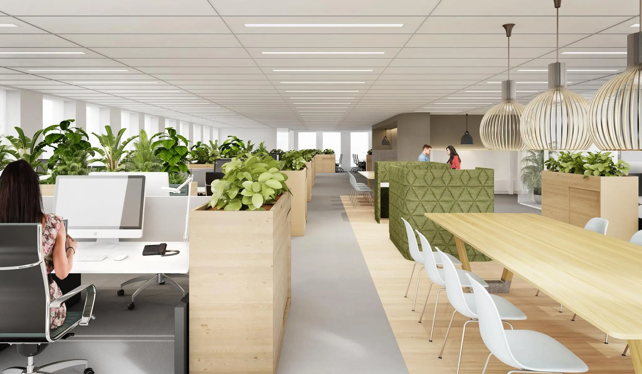 Modern kantoorinterieur aan de Fascinatio Boulevard met open werkplekken, veel groen en een grote vergadertafel.